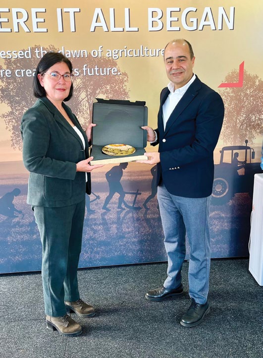 NAMPO fuarında plaket takdimi, WHERE IT ALL BEGAN pankartı önünde